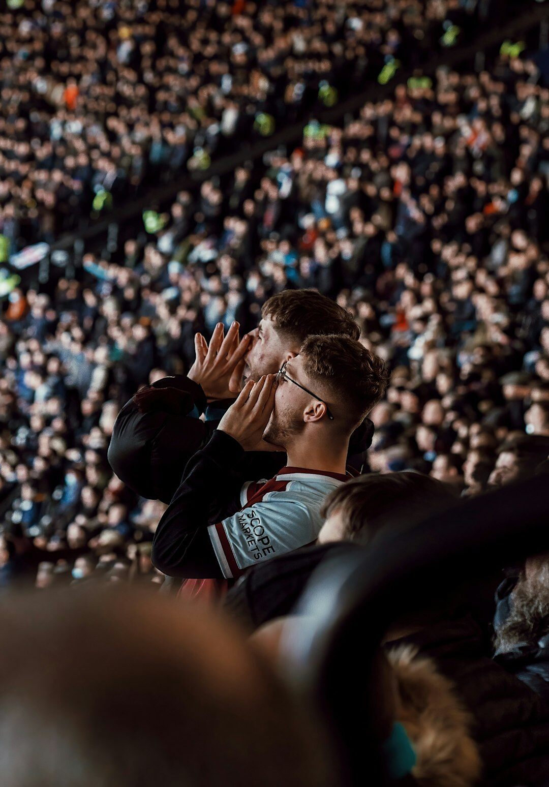 Football stadium full of fans celebrating during a match
